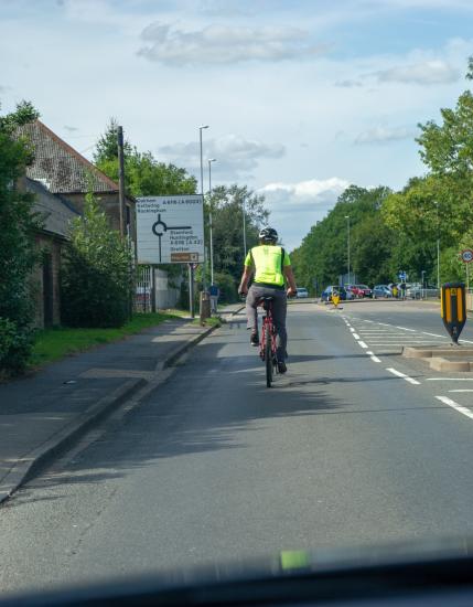 Cyclist riding in primary position in the road