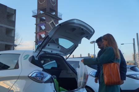 Couple using the boot of their car club car