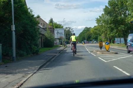 Photo of cyclist riding in primary position in the road