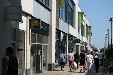 Willow Place, flags, shops, people busy walking