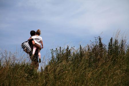 Father and daughter on a leisure walk enjoying the views