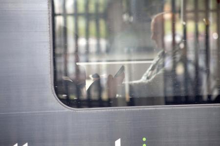 Man on the train using his phone