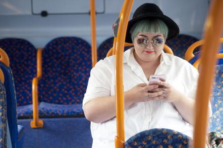 Lady using her phone on the bus