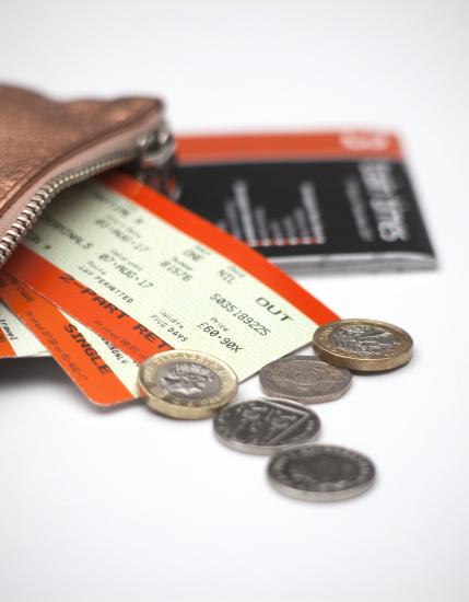Wallet with coins and train tickets